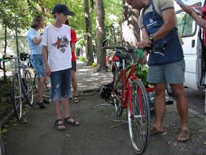 Todd watches Yorgos prepare his bike