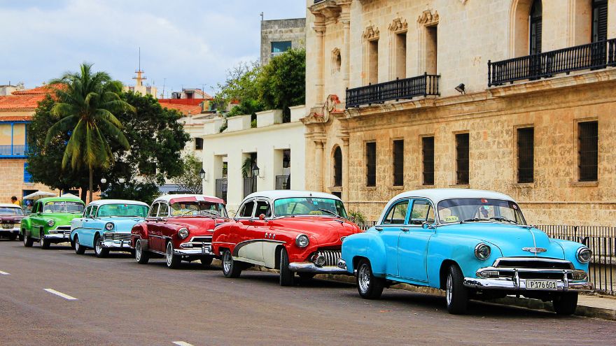 Line of classic cars parked in Havana, Cuba
